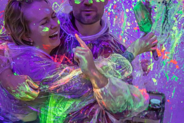 Splatter room with young adults having fun Splatter room with young adults having fun