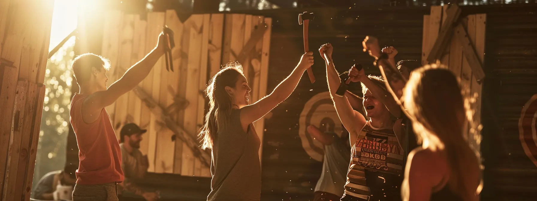 friends cheering and high-fiving as axes are thrown towards targets.