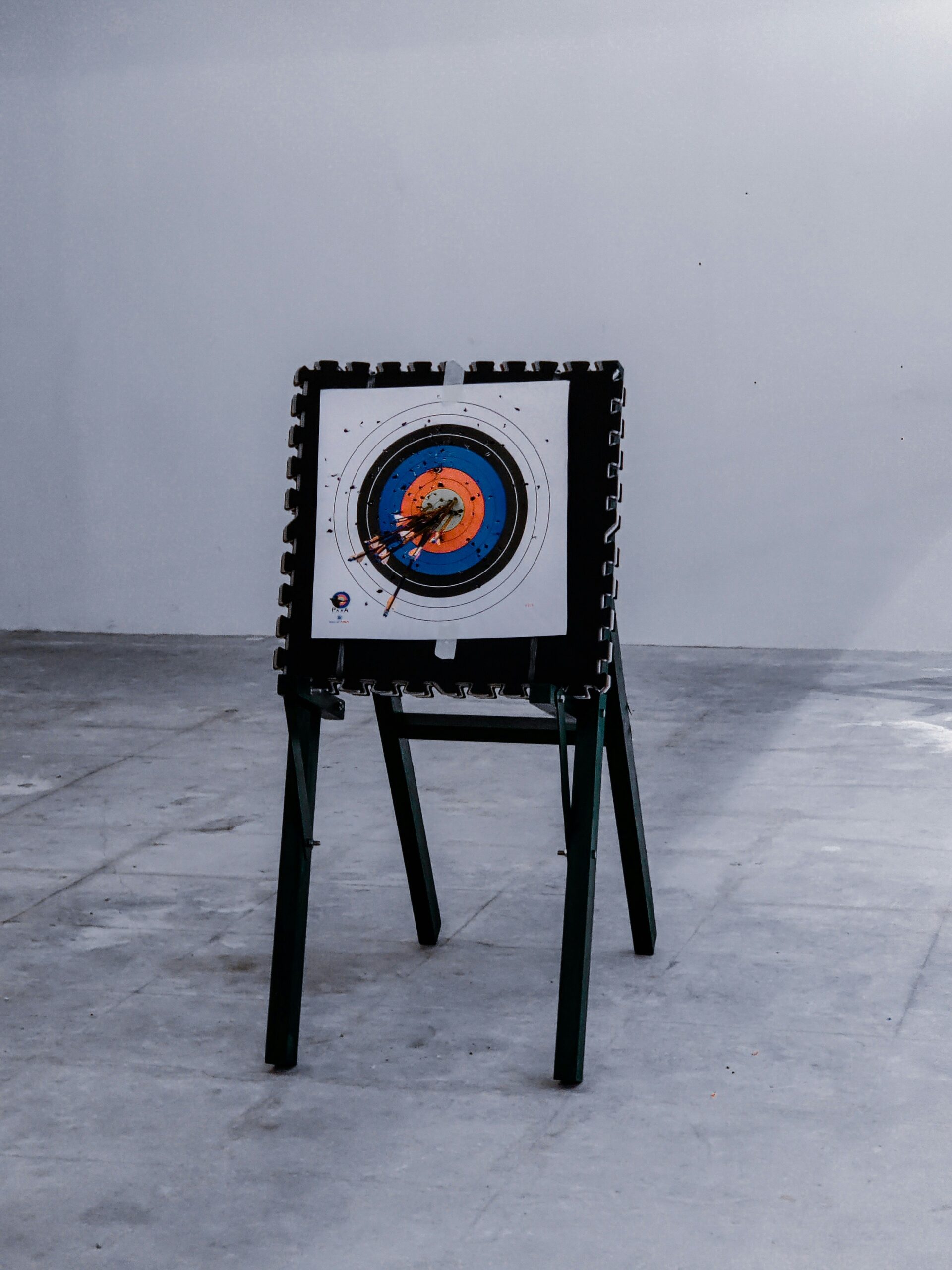A freestanding foam-framed target with multiple arrows demonstrates the use of durable materials ideal for building resilient and secure DIY Archery Tag targets.