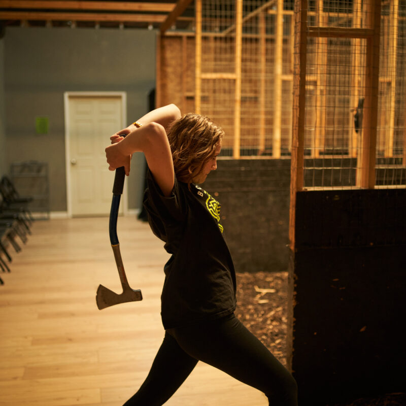 A girl throwing an axe