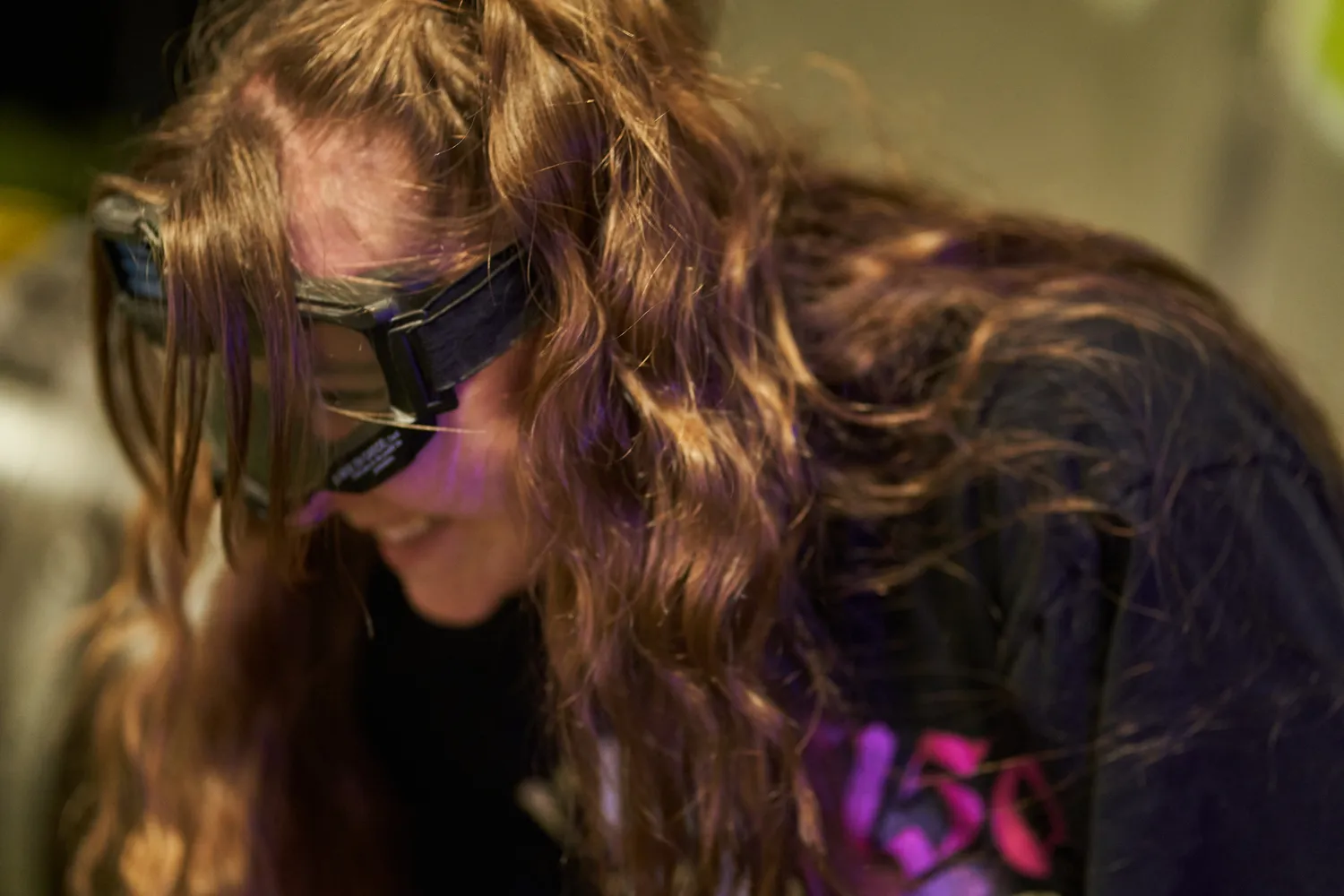 Close-up of a player adjusting protective goggles, highlighting a crucial accessory for safety during Nerf games.