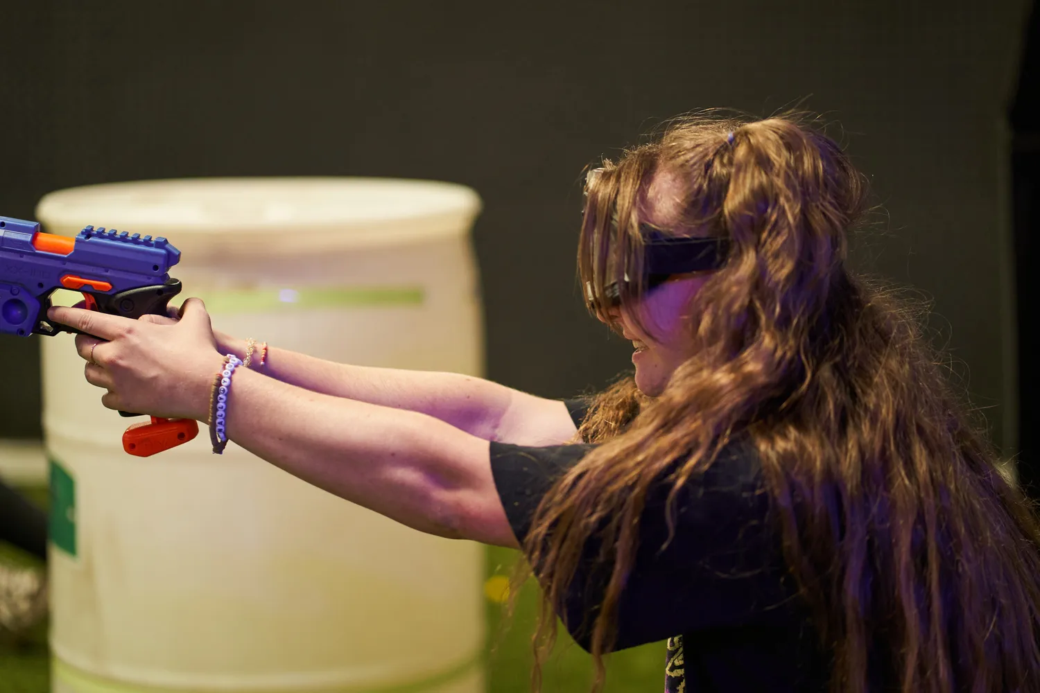 Player aiming a Nerf gun during a game, showcasing its robustness and suitability for active gameplay.