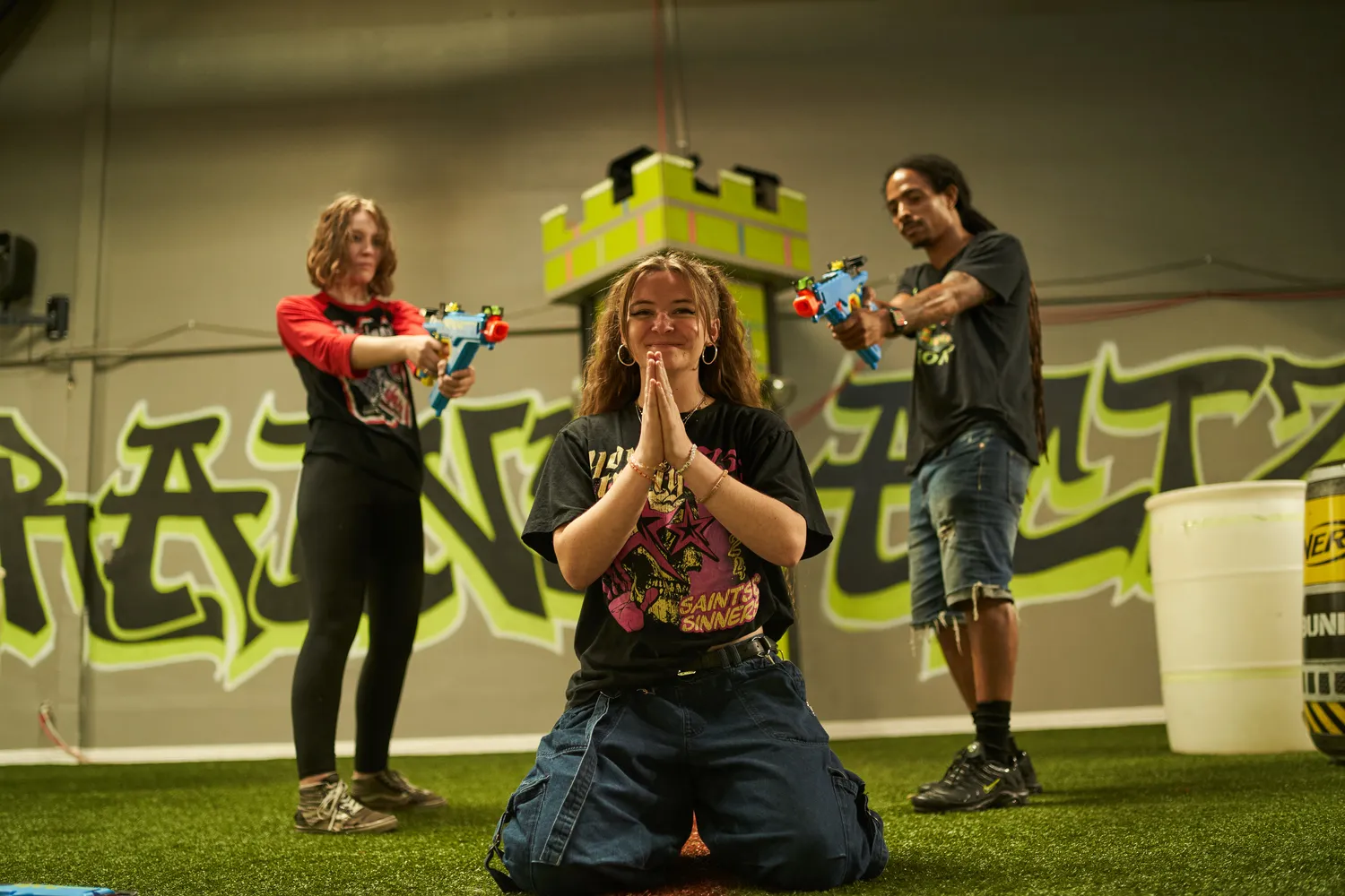 A group of players in a Nerf arena, engaged in a competitive battle.