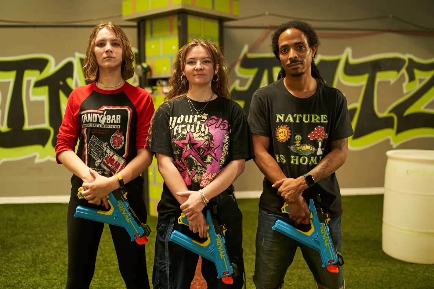 A group of Nerf battle participants in a stance ready for action, holding their blasters and positioning themselves for optimal performance. Effective team formations can significantly improve a team’s battlefield strategy.