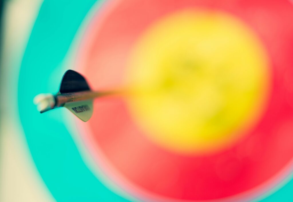 A close-up of an arrow hitting the bullseye on a colorful target, sparking creative ideas for bold and engaging DIY Archery Tag confrontations.