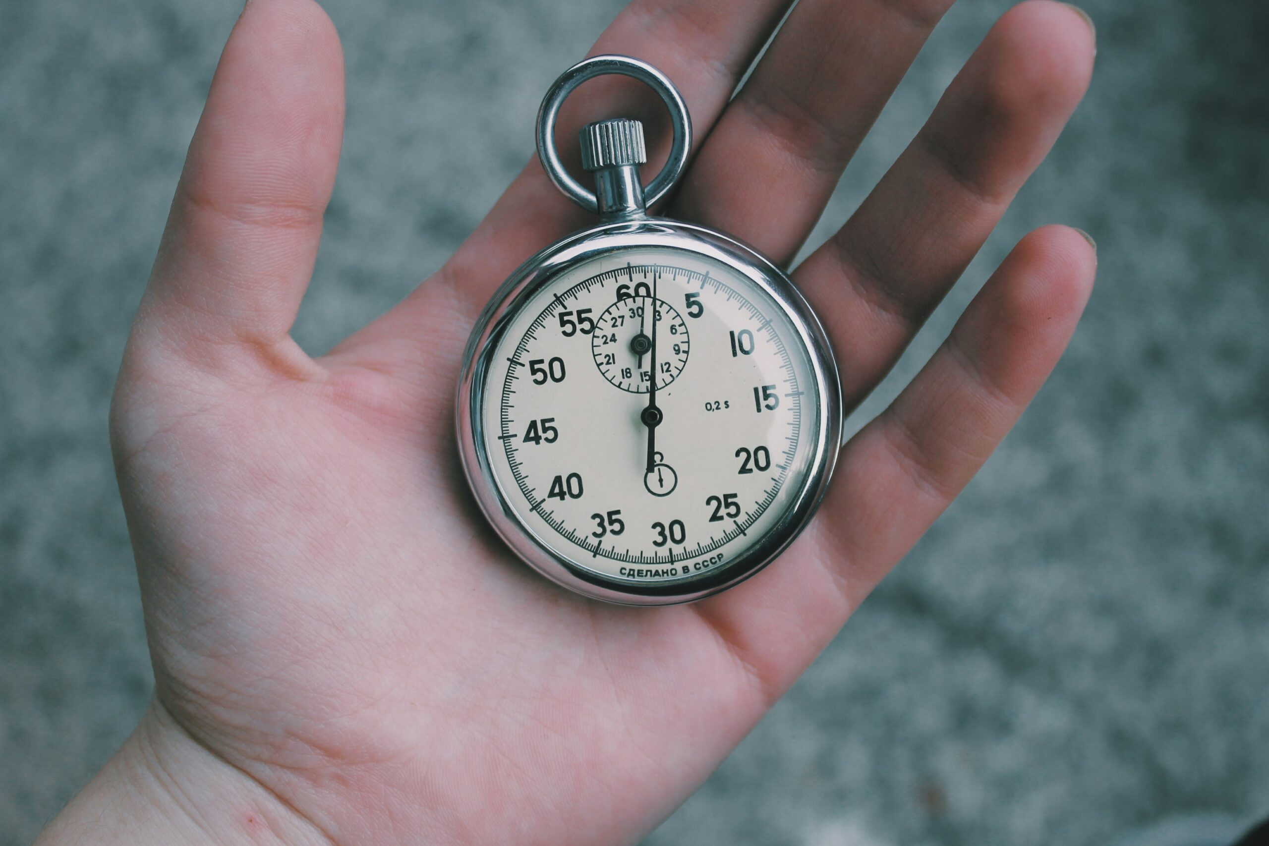 A hand holds a classic stopwatch, symbolizing the urgency and fast-paced decision-making in time-limited arrow tag game modes. - Brainy Actz Escape Rooms A hand holds a classic stopwatch, symbolizing the urgency and fast-paced decision-making in time-limited arrow tag game modes.