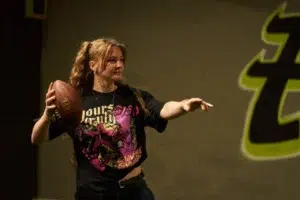 Player preparing to throw a Bowlball in a team arena, emphasizing how ready-to-use gear supports group coordination and competitive strategy. - Brainy Actz Escape Rooms Player preparing to throw a Bowlball in a team arena, emphasizing how ready-to-use gear supports group coordination and competitive strategy.