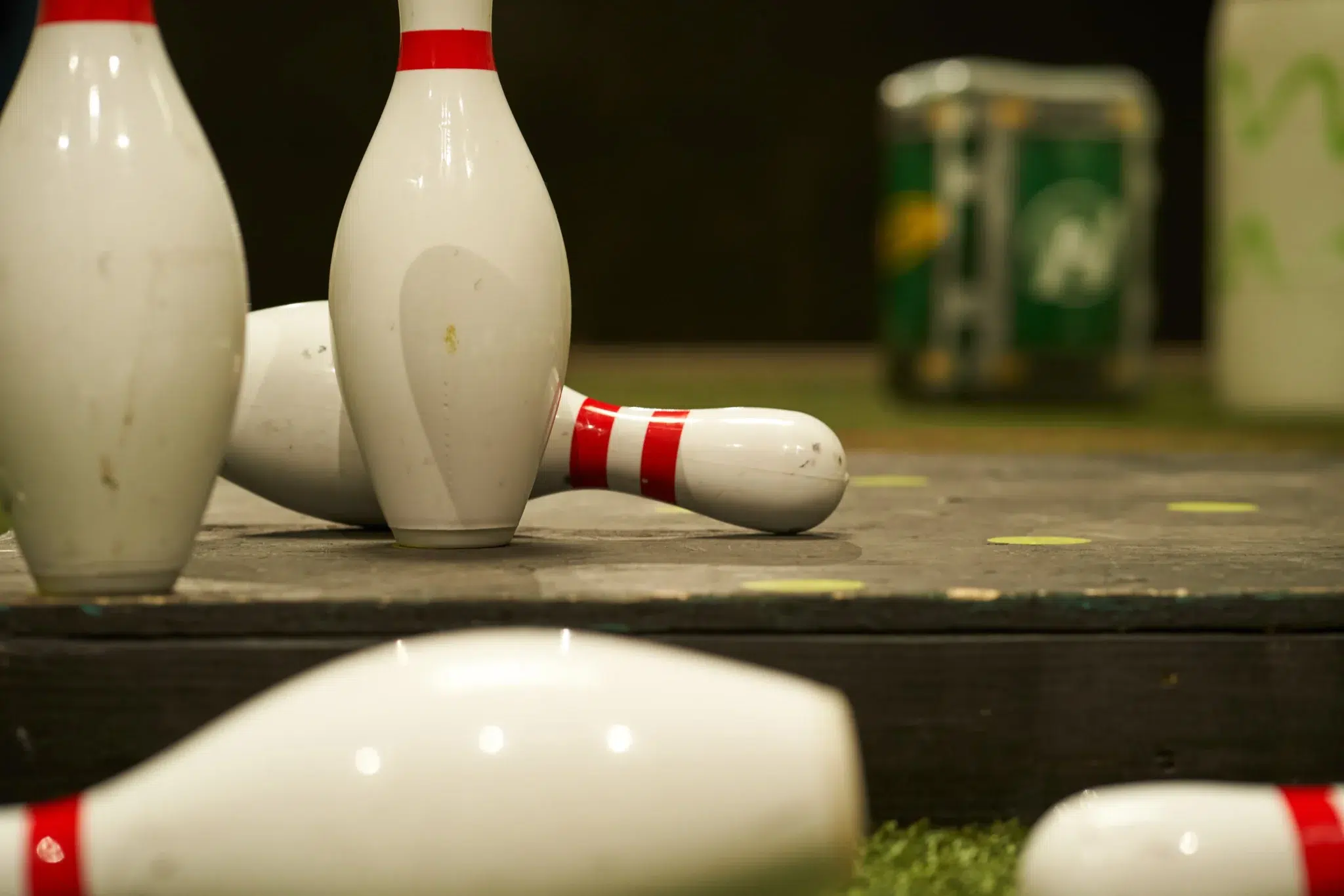Scattered pins on turf capture the playful chaos at the heart of Bowlball’s social and sporty vibe.