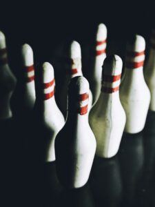 Keep gameplay safe by spacing out pins and staying alert during every roll in high-energy group activities like Bowlball. - Brainy Actz Escape Rooms