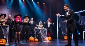 fd016a8c 3c39 4155 bb47 cbcfdc3fdce9webp - Brainy Actz Escape Rooms A spooky, Halloween-themed game show in full swing, with excited participants and eerie decorations