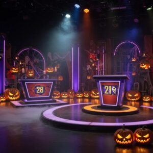 halloween game show set with glowing jack o lanterns and spooky decorations 414446b9 6d36 405b a62d 729977a59d54webp - Brainy Actz Escape Rooms Halloween game show set with glowing jack-o’-lanterns and spooky decorations